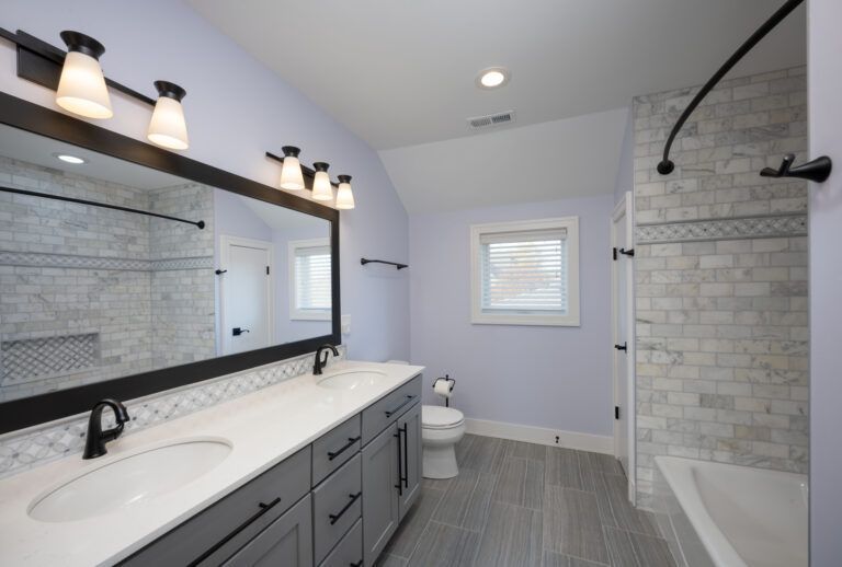 A bathroom with a toilet , sink , and mirror