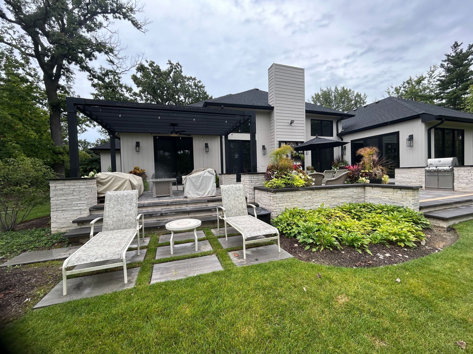 A large house with a patio area in front of it.