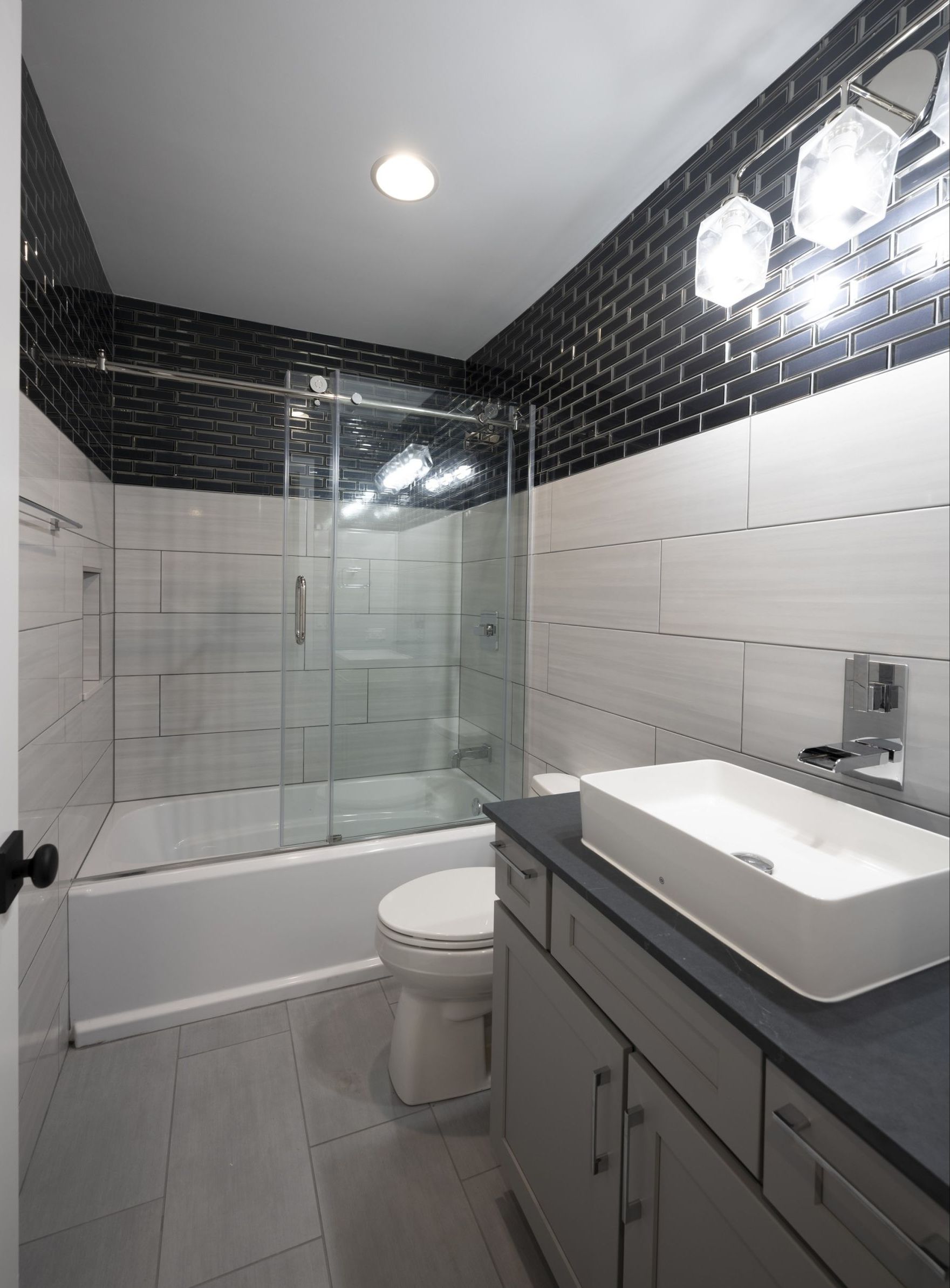 A bathroom with a toilet a sink and a bathtub