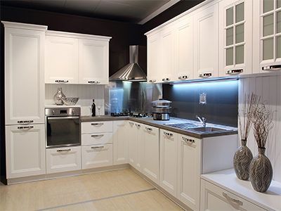 remodeled kitchen with white cabinets and dark walls