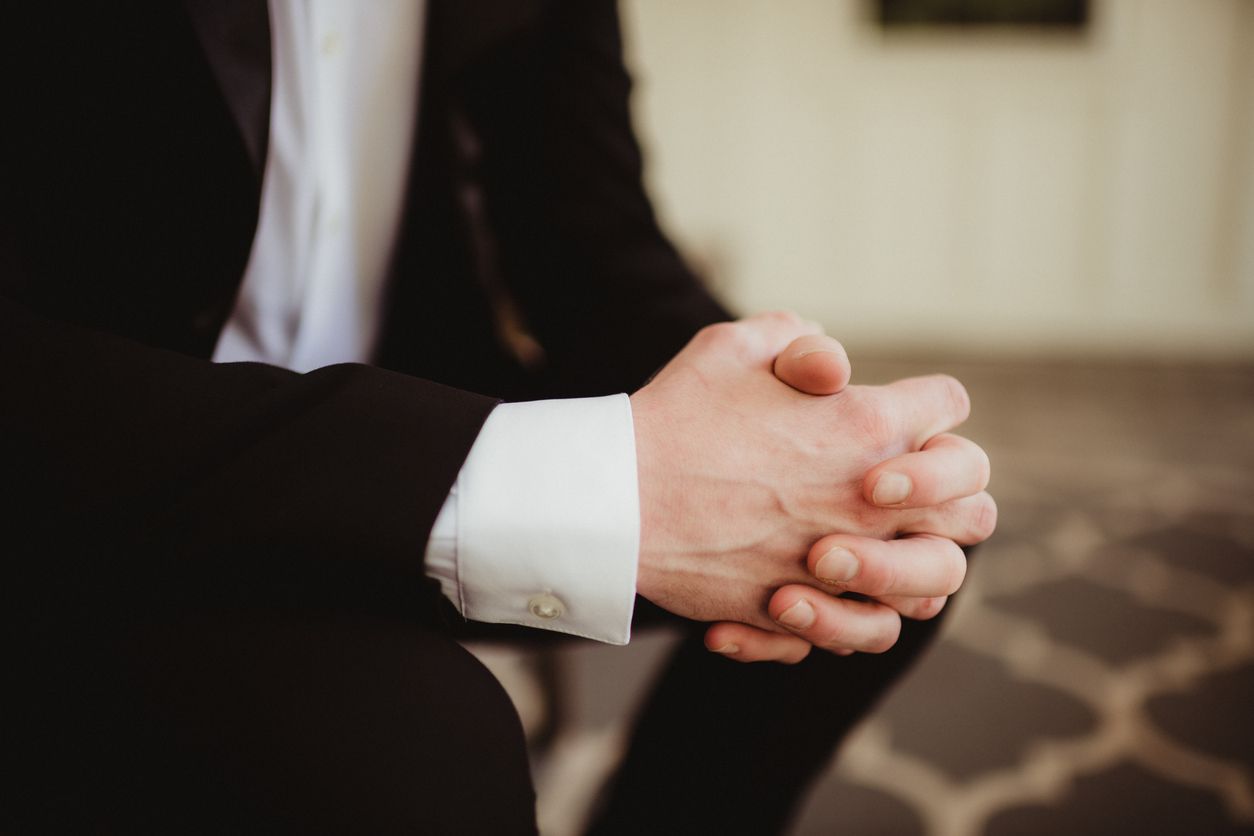 funeral director close up with hands folded