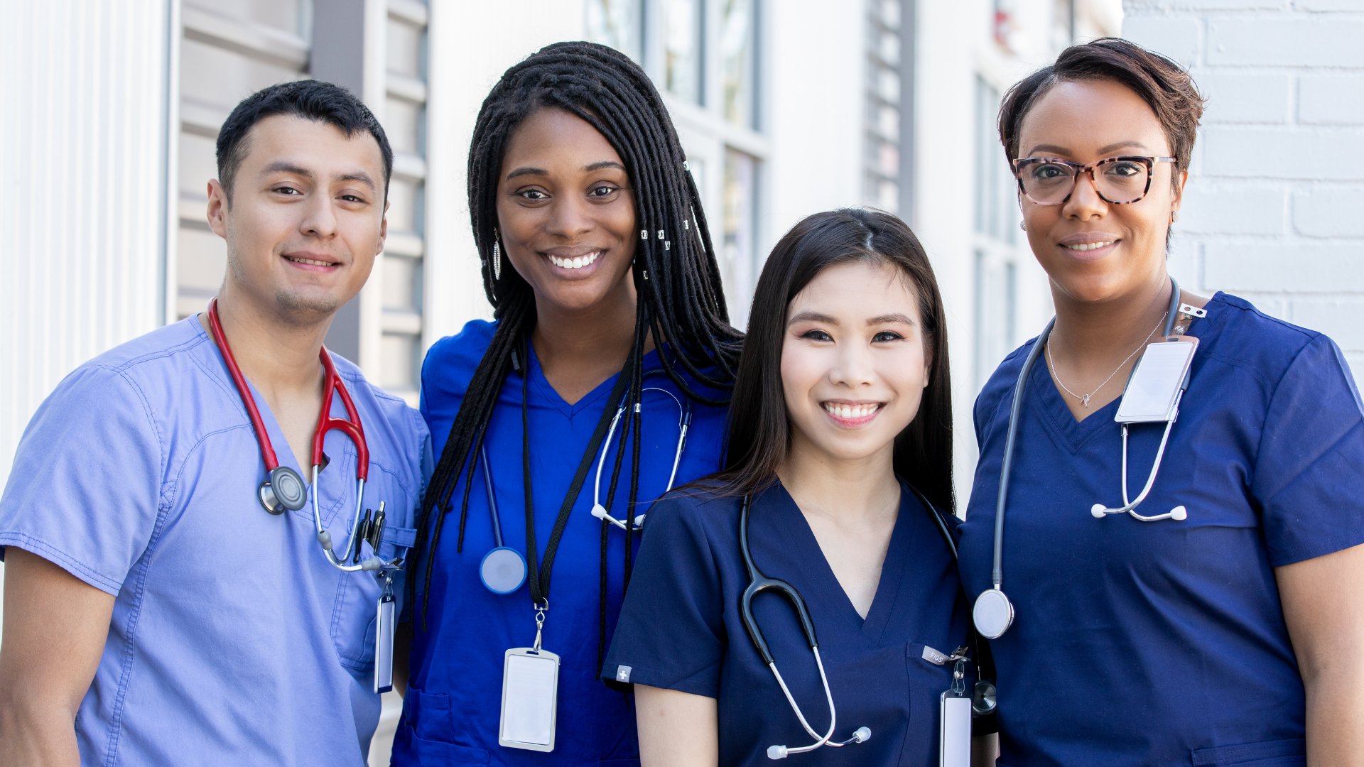 Healthcare workers in scrubs standing together