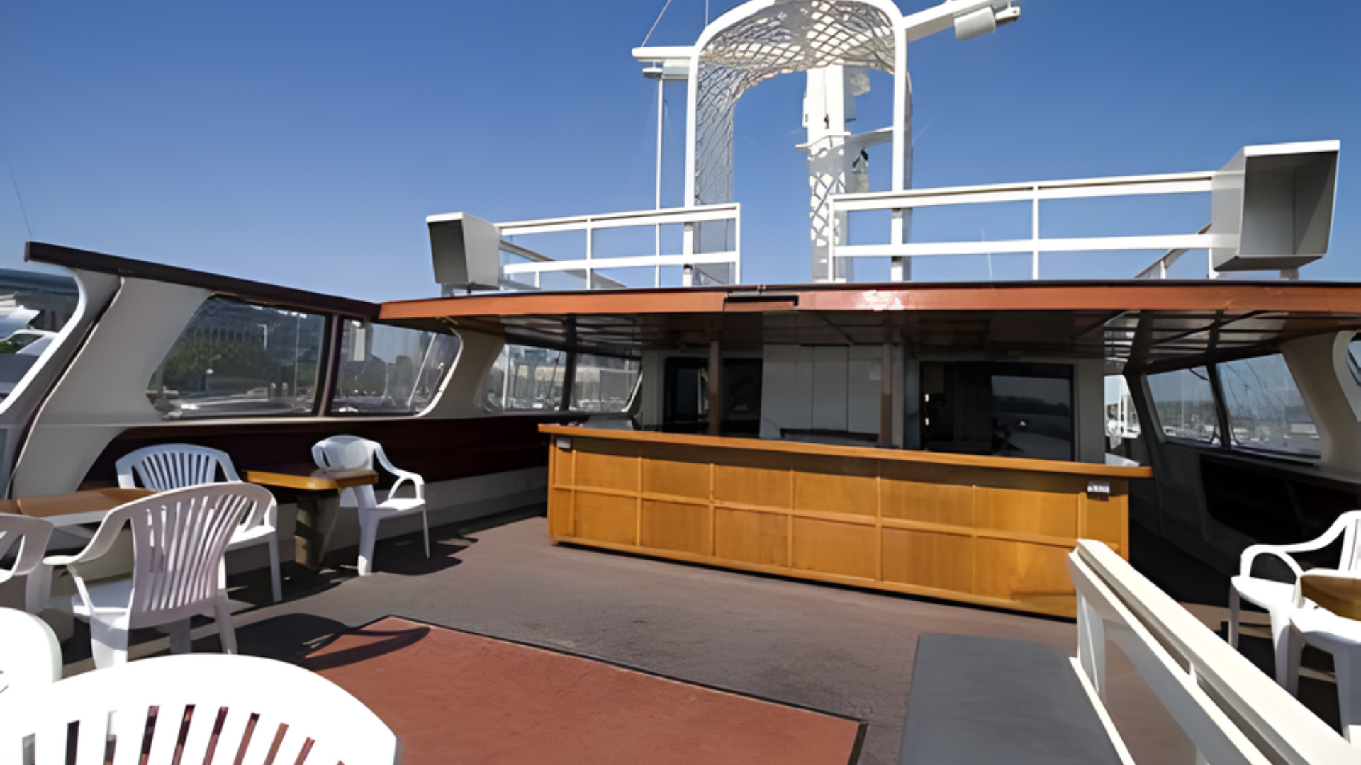 White two-deck passenger ferry on water, angled side view with blue stripe and orange trim