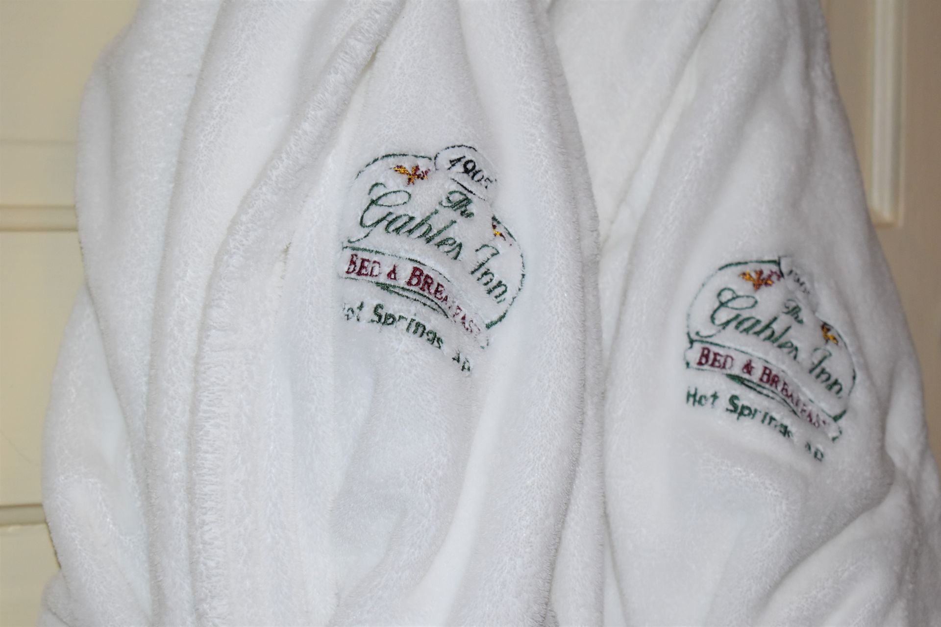 Two white bathrobes embroidered with 