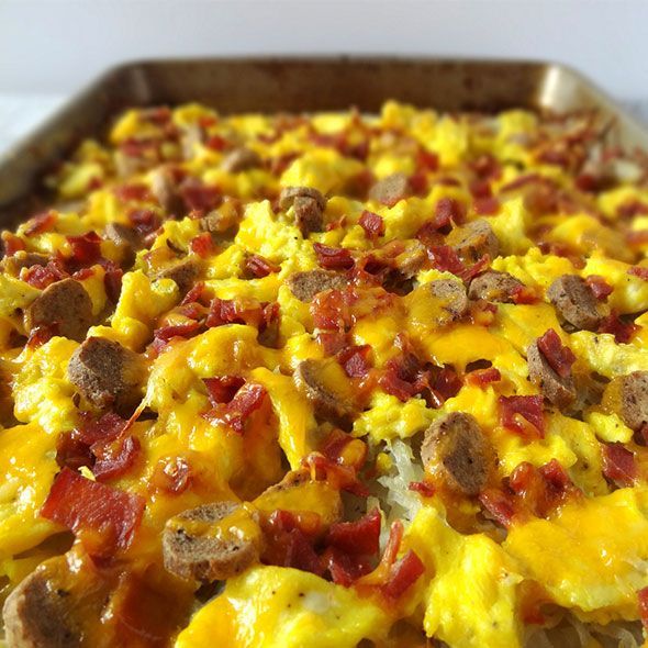 Sheet pan breakfast with eggs, sausage, bacon, and cheese.