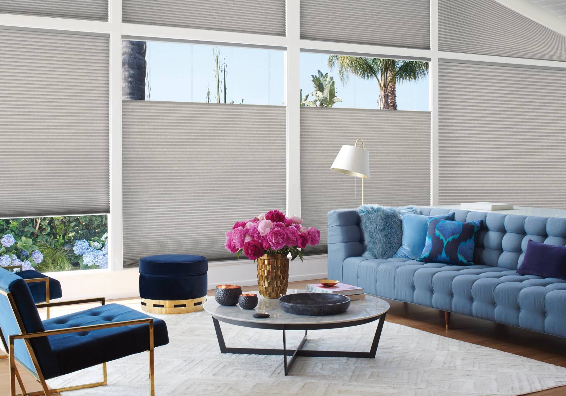 Hunter Douglas cellular shades covering large living room windows.