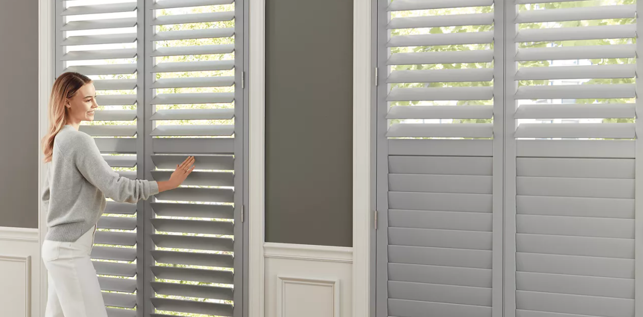Hunter Douglas Heritance® Wood Shutters covering large living room windows.