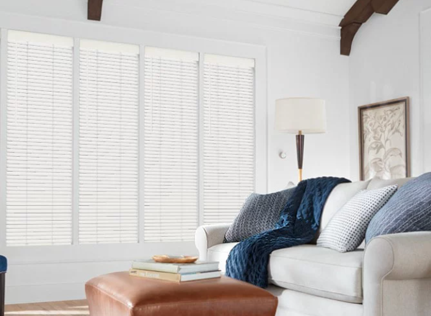 Hunter Douglas Parkland® Wood Blinds covering four large living room windows.