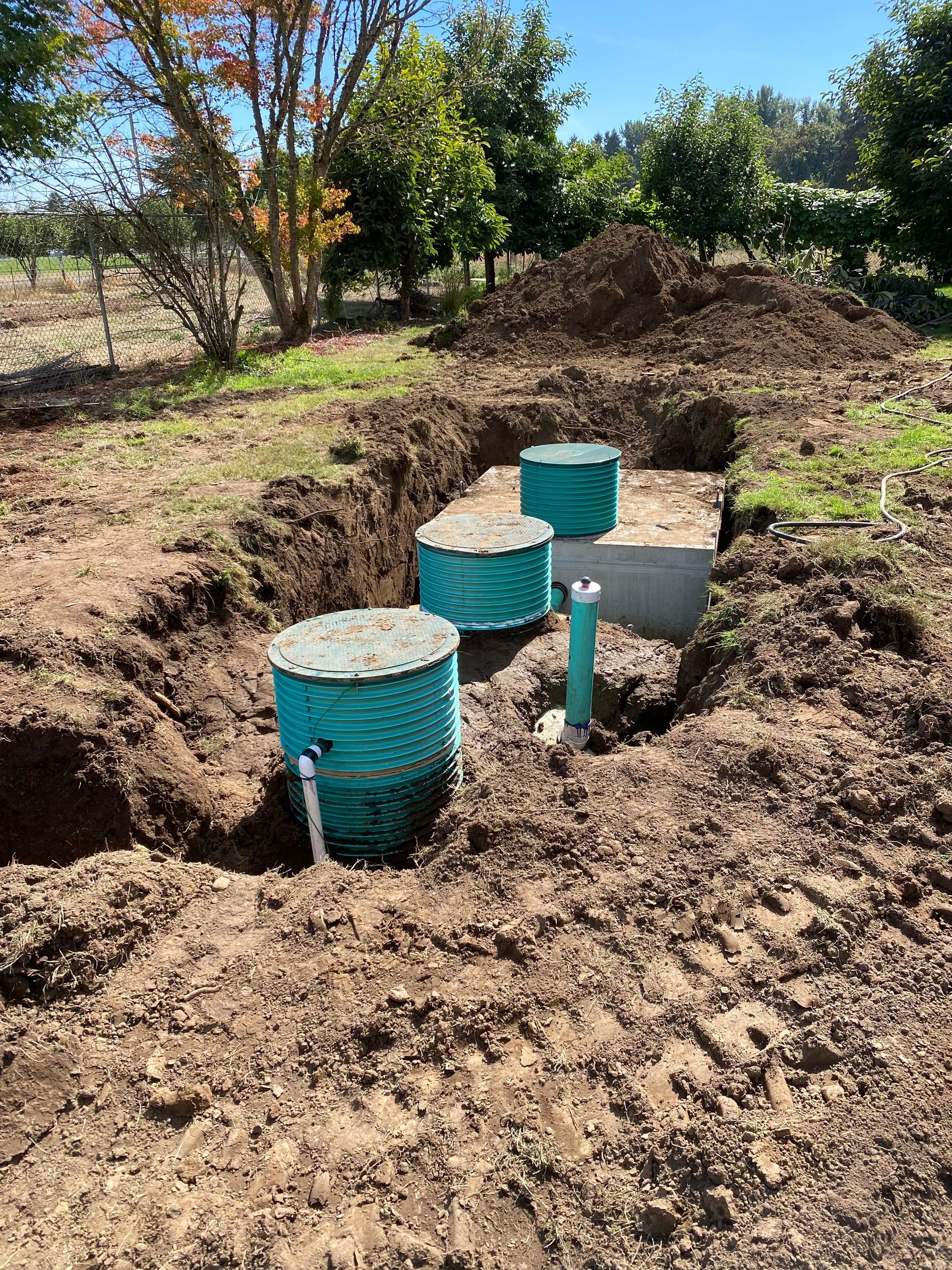 Partially buried treatment tank and UV disinfector with pipe connected. Partially buried treatment tank and UV disinfector with pipe connected.