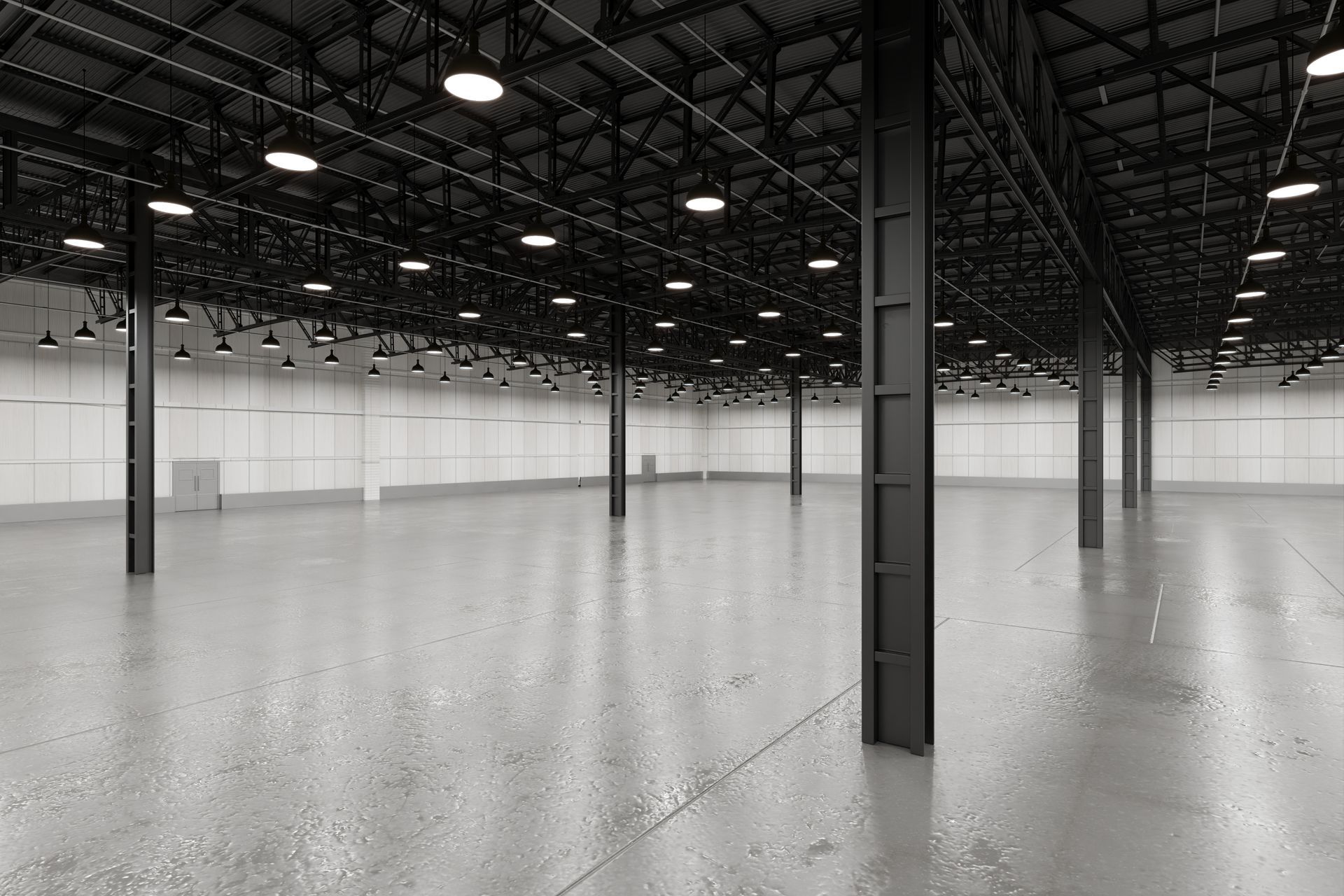 Empty industrial warehouse with polished concrete floor and black ceiling beams
