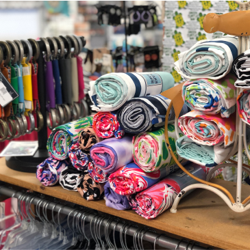A bunch of rolls of fabric are stacked on top of each other