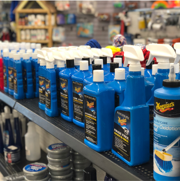 Several bottles of meguiar 's products are on a shelf