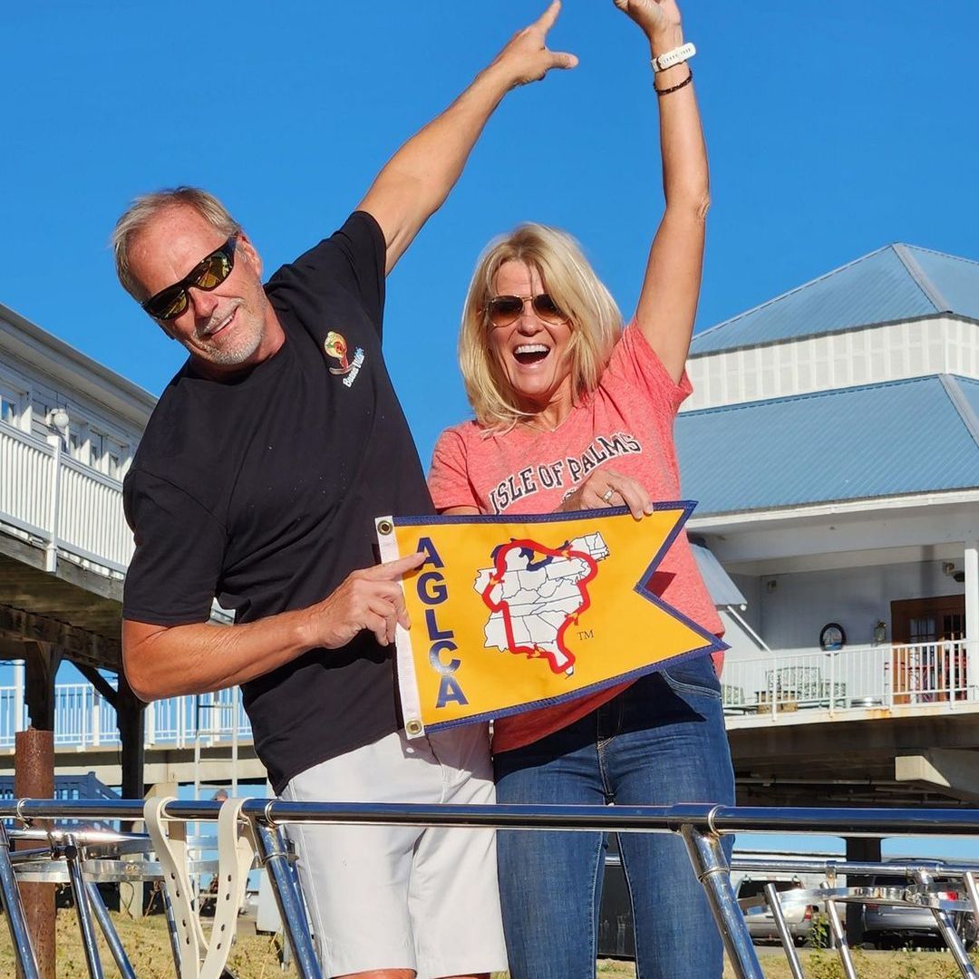 A man and a woman holding a flag that says a.c.l.a.