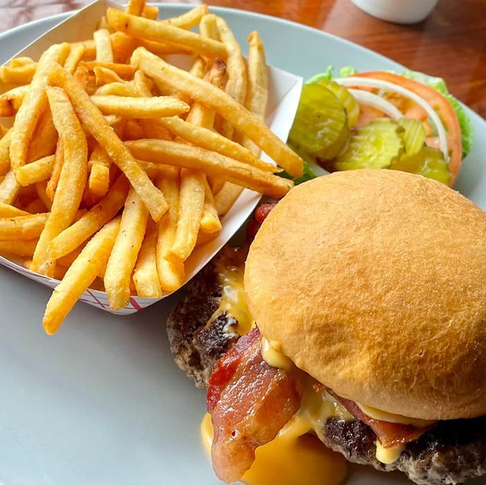A hamburger and french fries on a white plate