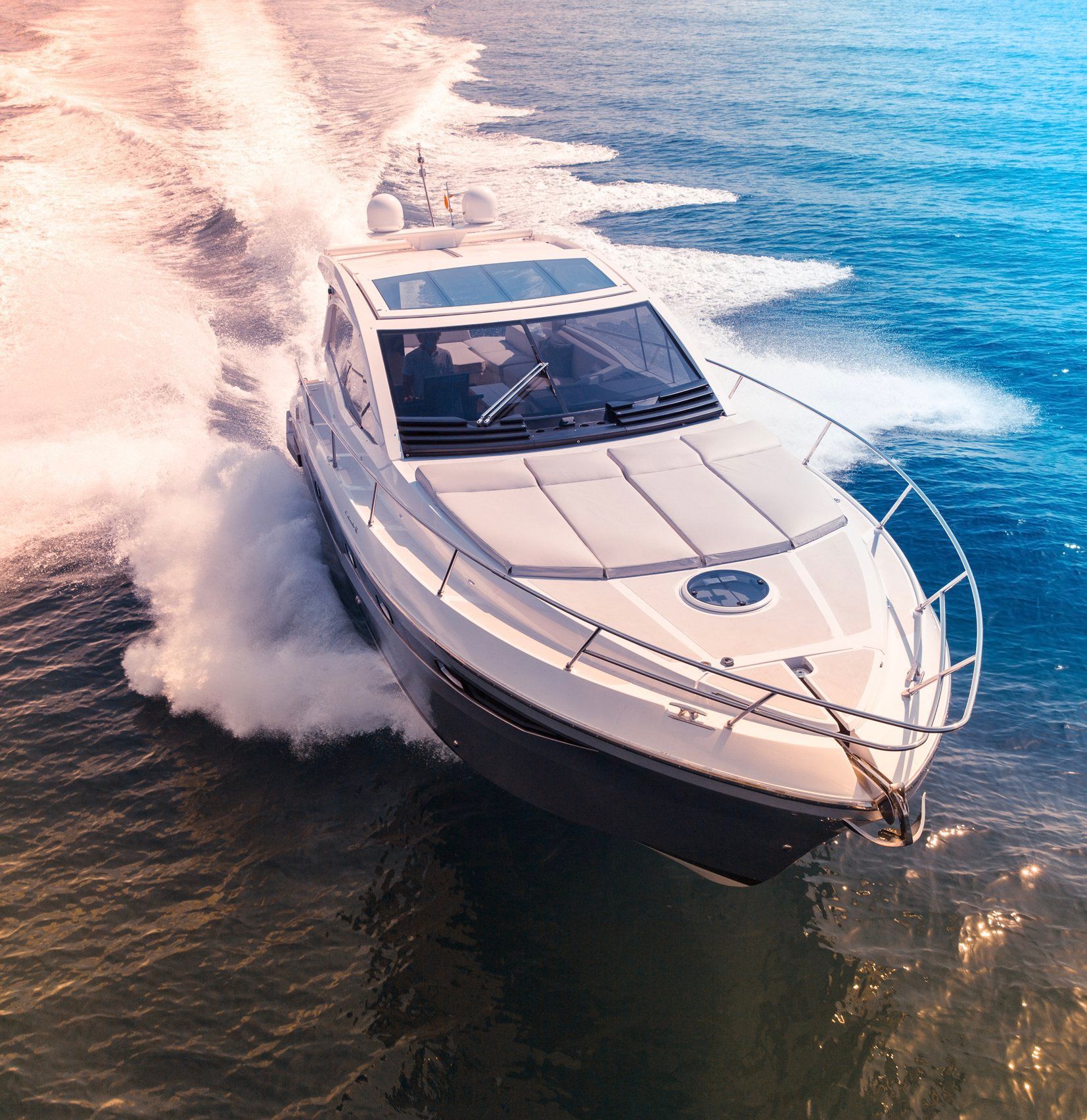 A white boat is floating on top of a body of water.