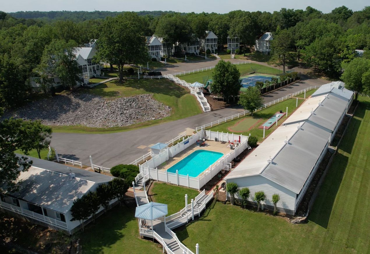 An aerial view of a residential area with a swimming pool in the middle.