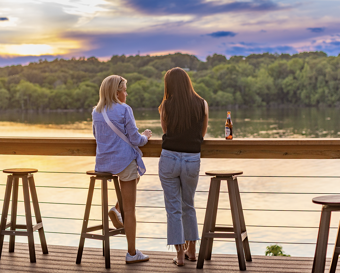 A group of people are sitting around a picnic table.