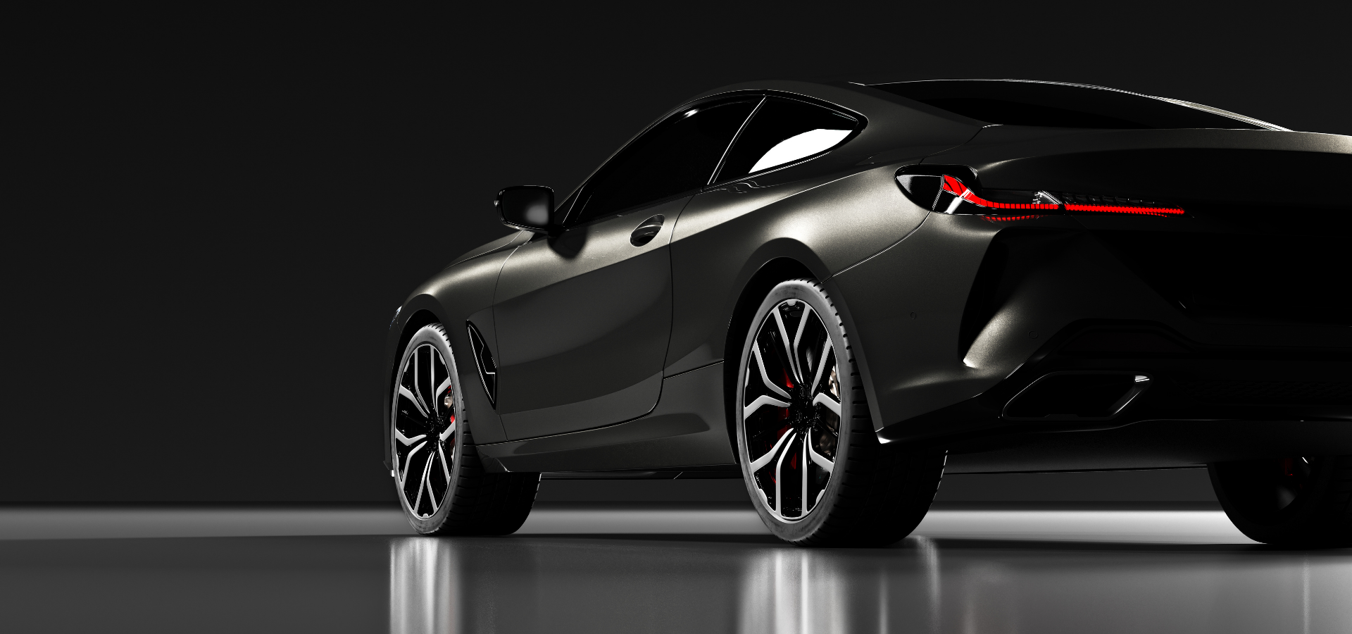 Sleek black sports coupe on a dark studio backdrop, rear three-quarter view with reflective floor
