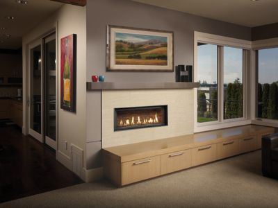 A living room with a fireplace and a painting on the wall