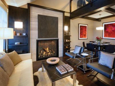 There is a fireplace in the middle of the living room.
