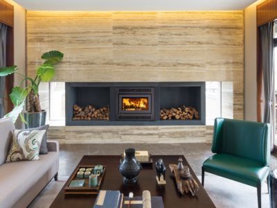 A living room with a fireplace and a couch and chairs