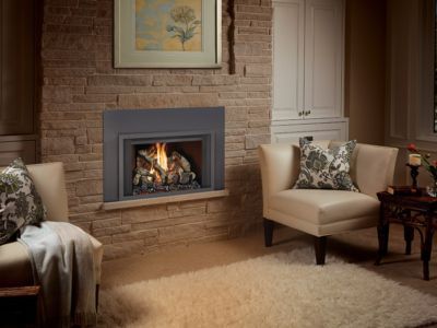 A living room with a fireplace and two chairs.