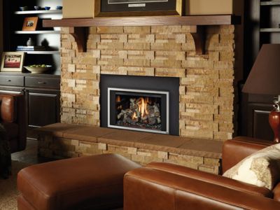 A living room with a brick fireplace and leather furniture