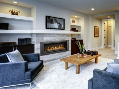 There is a fireplace in the middle of the living room.