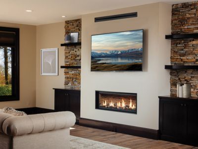 A living room with a fireplace and a flat screen tv