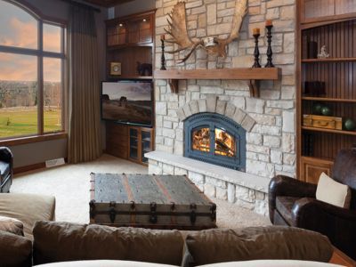 A living room with a fireplace and a large window