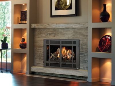 A living room with a fireplace and a picture on the wall.