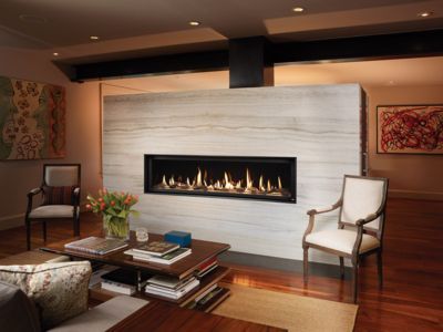 A living room with a fireplace and a coffee table