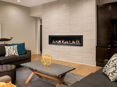 A living room with a fireplace , couch , coffee table and television.