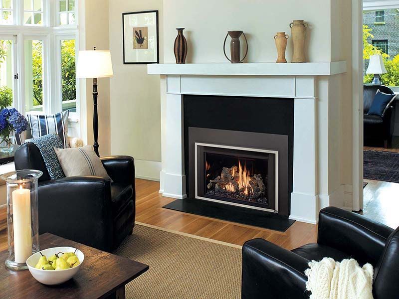 There is a fireplace in the middle of the living room.