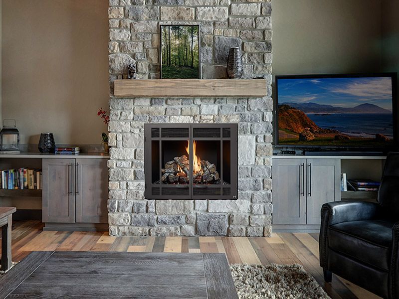 A living room with a fireplace and a flat screen tv