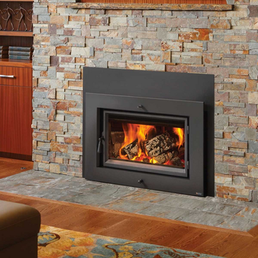 A fireplace in a living room with a brick wall