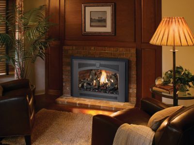 A living room with a fireplace and a lamp