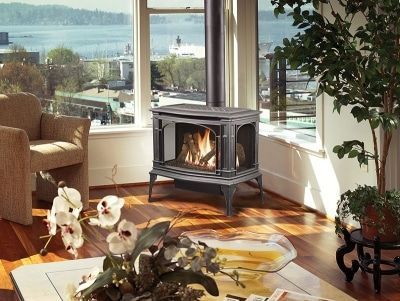 A living room with a fireplace and a view of the ocean