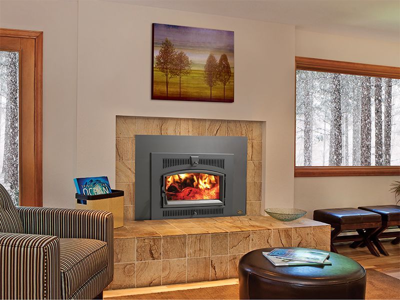 A living room with a fireplace and a painting on the wall