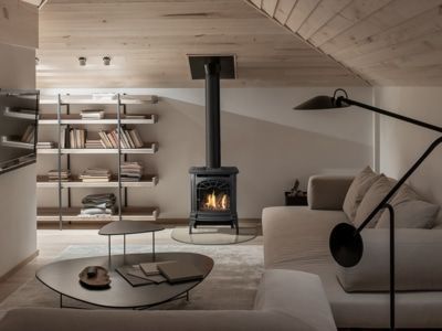 A living room with a wood stove and a couch