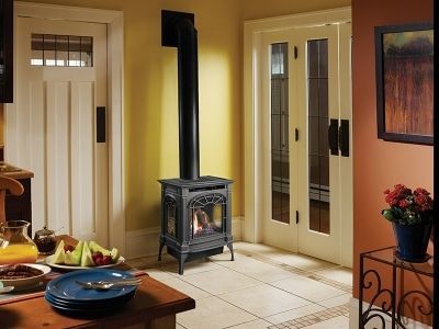 A room with a wood stove in the middle of it