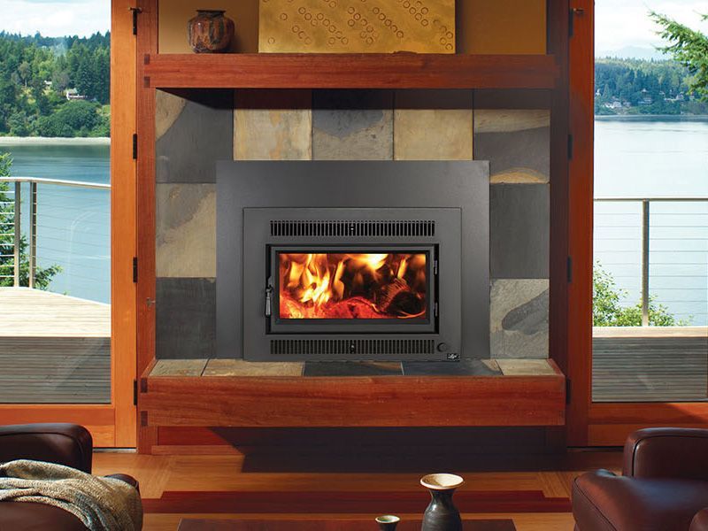 A living room with a fireplace and a view of a lake