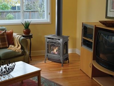 A living room with a fireplace , couch , table and television.