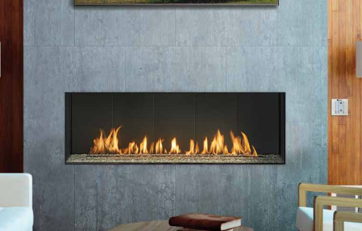 A living room with a fireplace and a table with books on it.