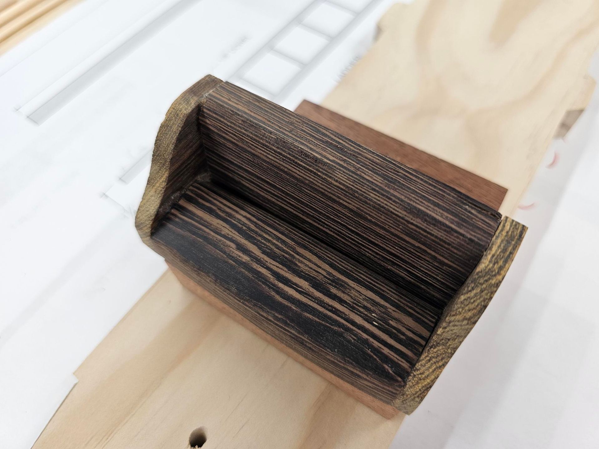 Wooden interior, sitting on a light-colored wooden surface.