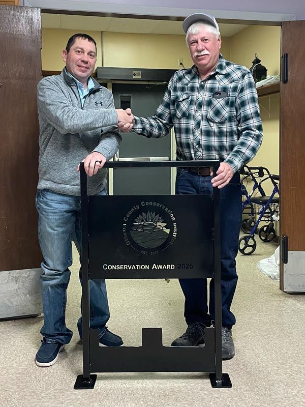 two men shaking hands behind a podium