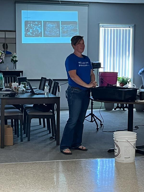woman speaking to a group in a classroom setting