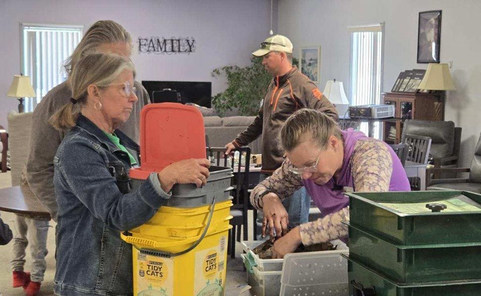 people working with dirt/soil in a classroom setting