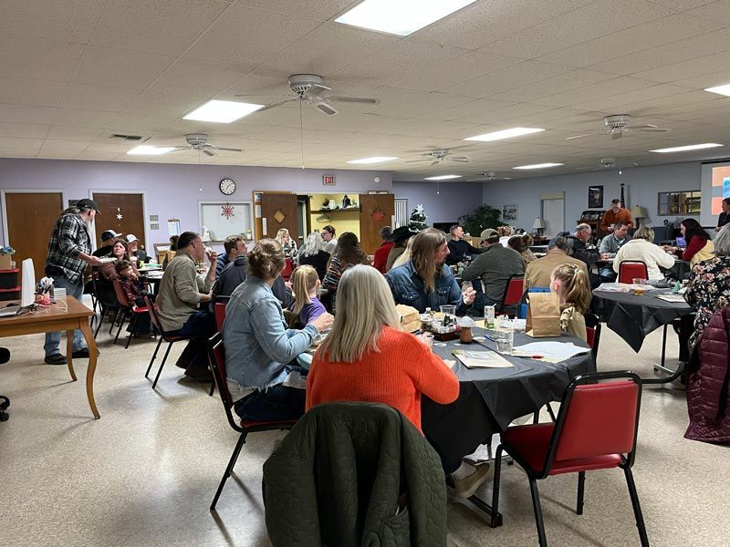 groups of people sitting at round tables