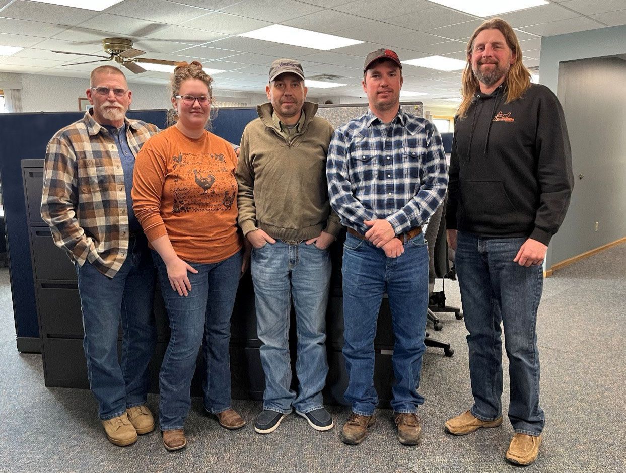 group of people posing in a office